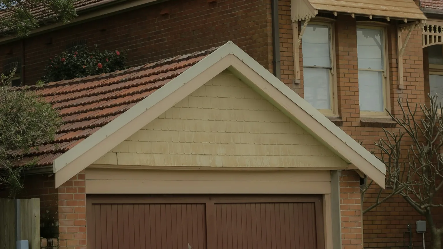 Brick house windows, tiled garage roof and exterior building details in Newcastle, NSW.