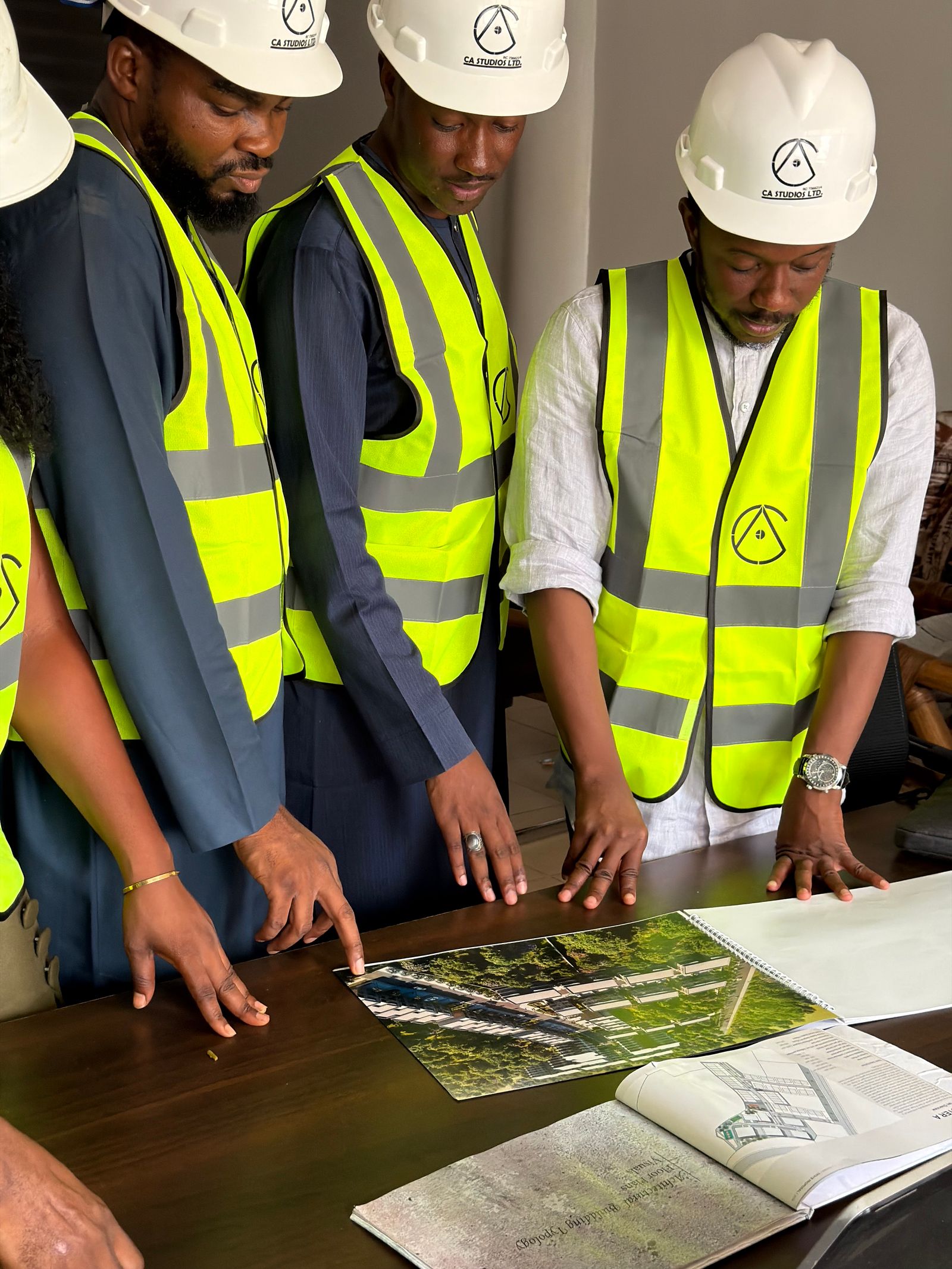 Development team reviewing site plans together before construction