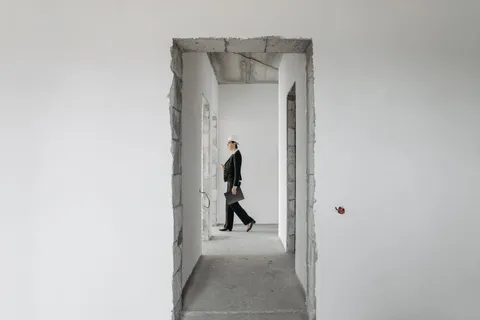 Property professional inspecting an unfinished building