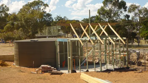 Timber-framed structure under construction on a residential site