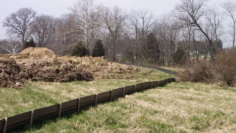 Silt fence installed as a sediment control barrier on a construction site