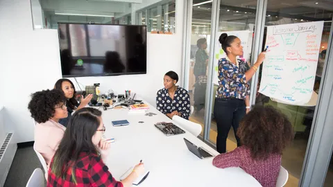 Property professionals discussing plans across a meeting table