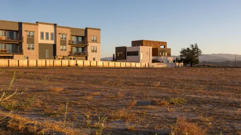 Undeveloped land parcel for development in front of new townhouses