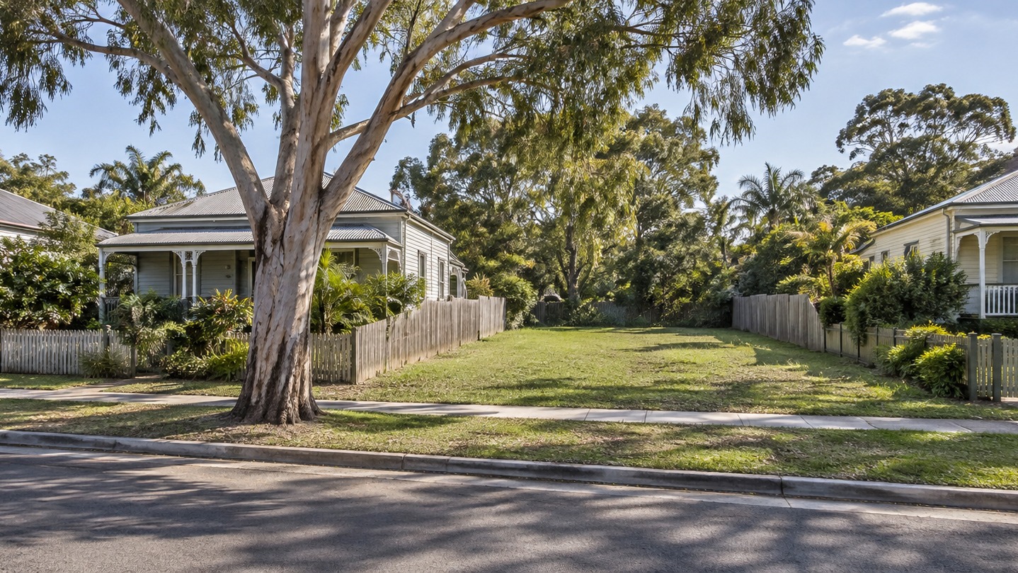 Queensland weatherboard street with an empty lot between houses