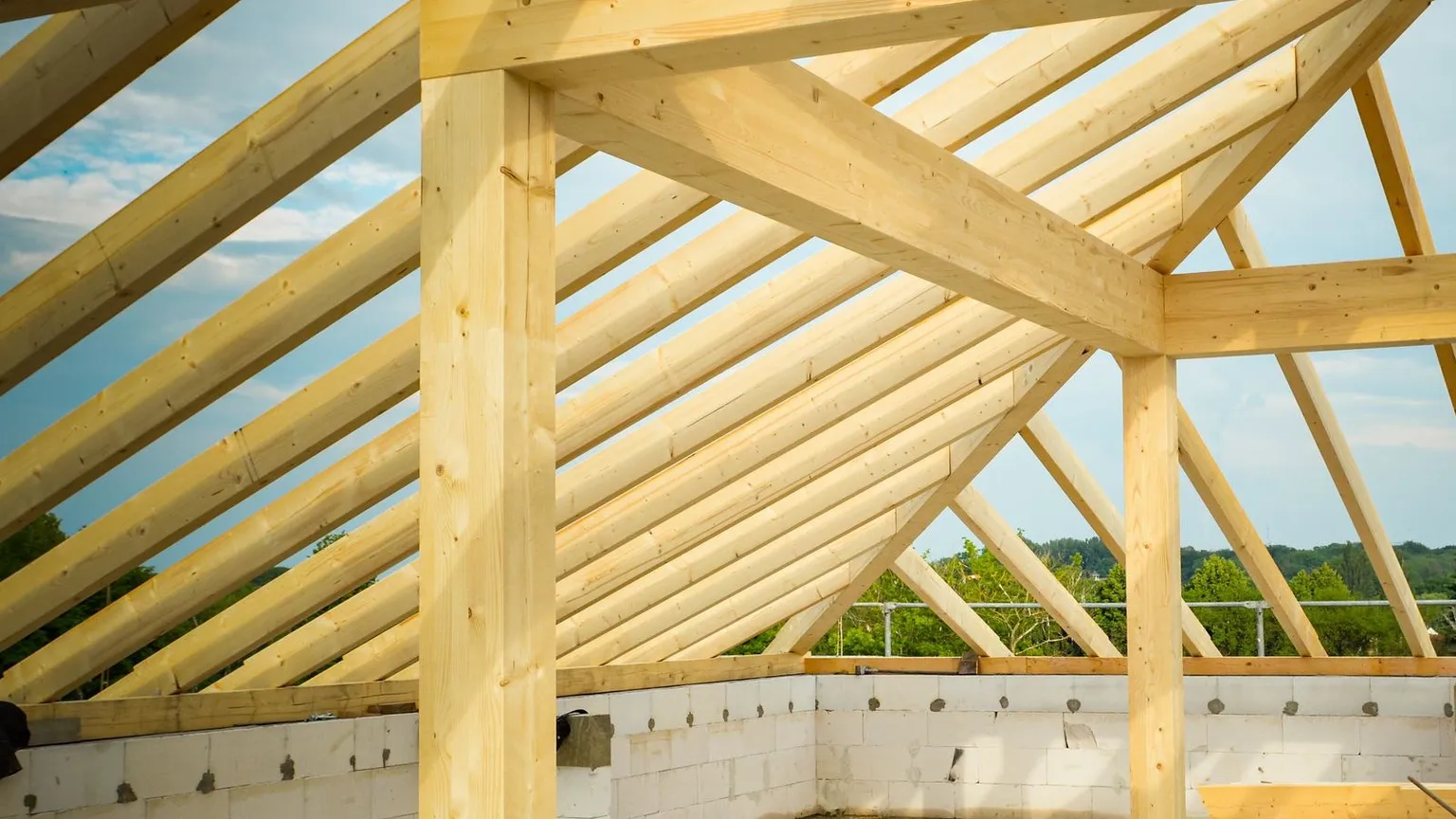 Timber roof frame and trusses over blockwork walls during construction of a residential building