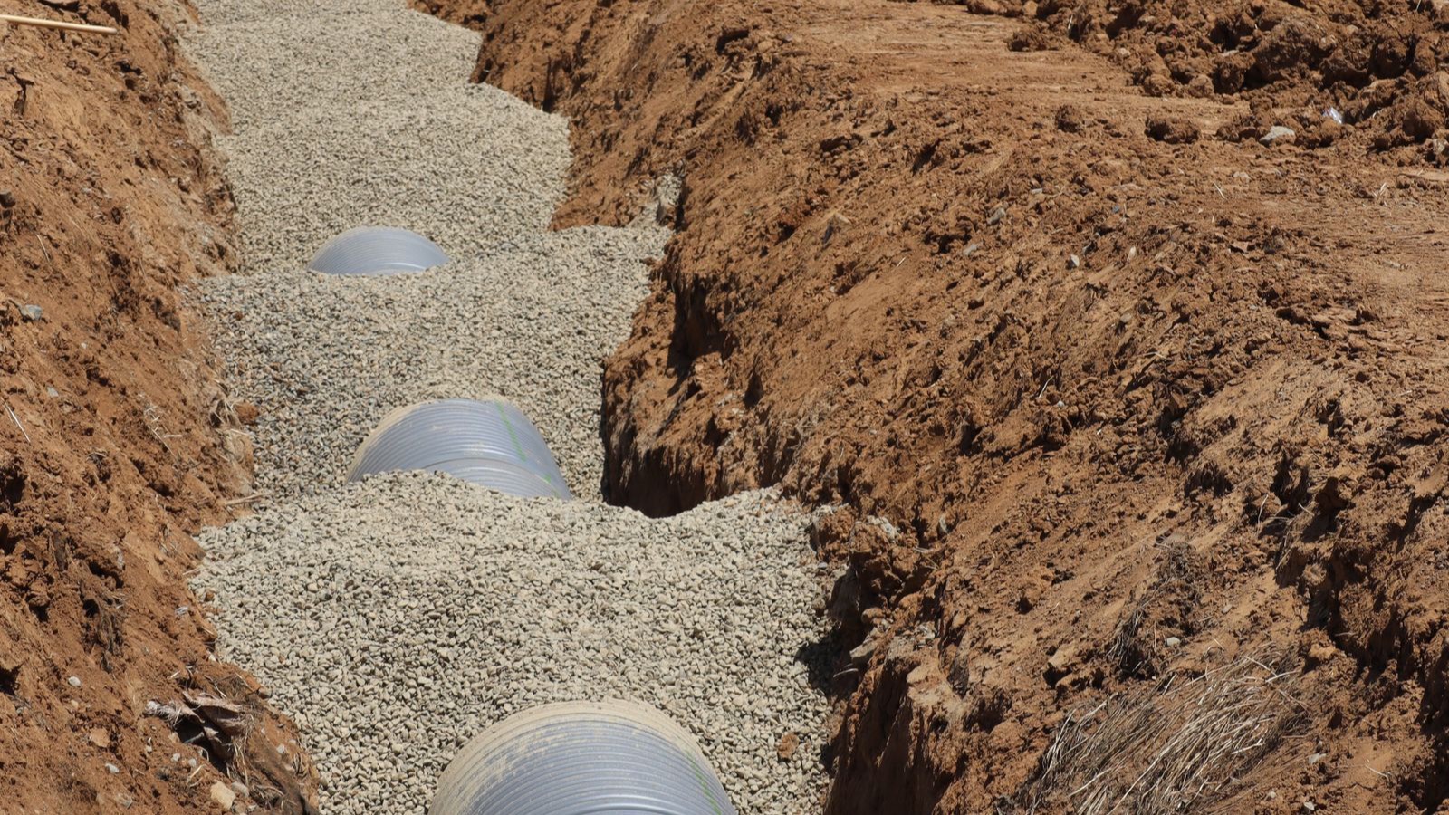 Large service pipes laid in a trench during underground infrastructure works