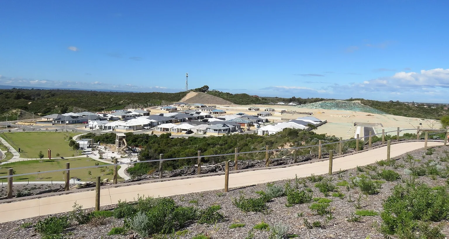 A cleared residential subdivision under construction in Western Australia, with new homes built and vacant graded lots awaiting construction.
