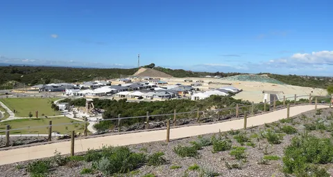 New housing estate under construction with built homes and vacant graded lots.
